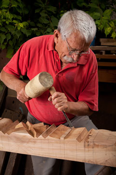 woodcarver using a mallet and a gouge